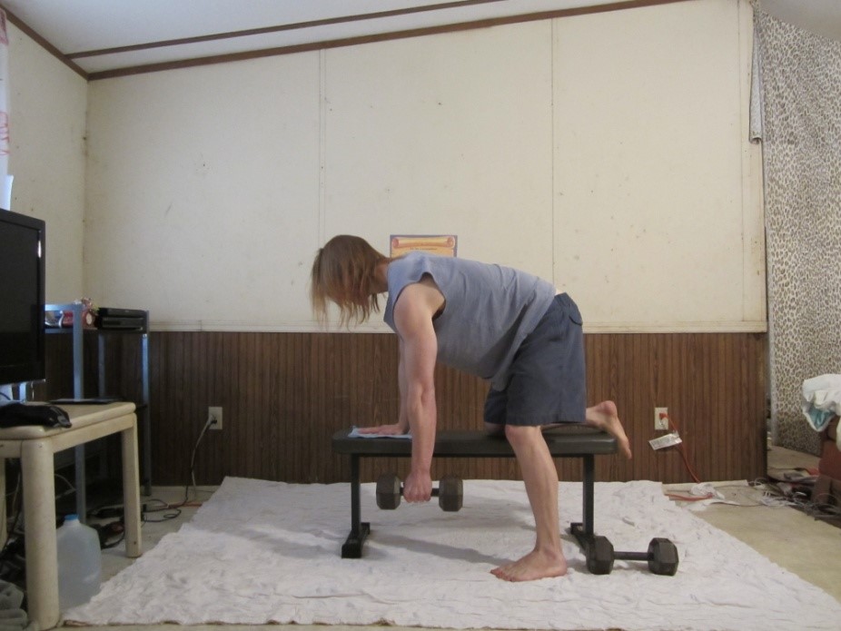 Dumbbell row, dumbbell back row picture demonstrating the beginning of the repetition for the left arm from a side viewpoint.