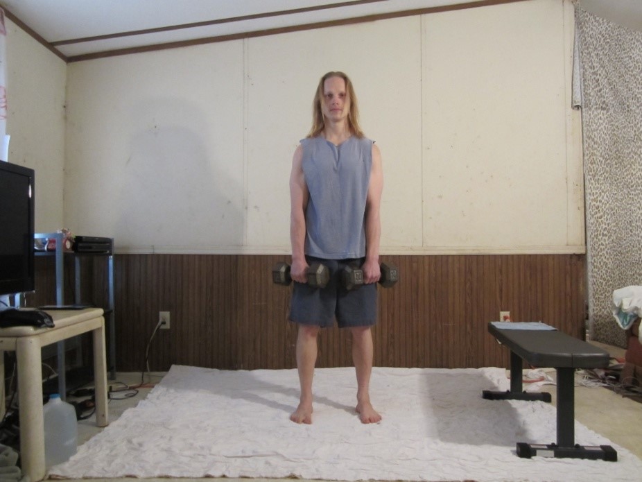 Dumbbell Dead Lift, Dumbbell stiff leg lift picture demonstrating the beginning of the repetition from a front viewpoint.